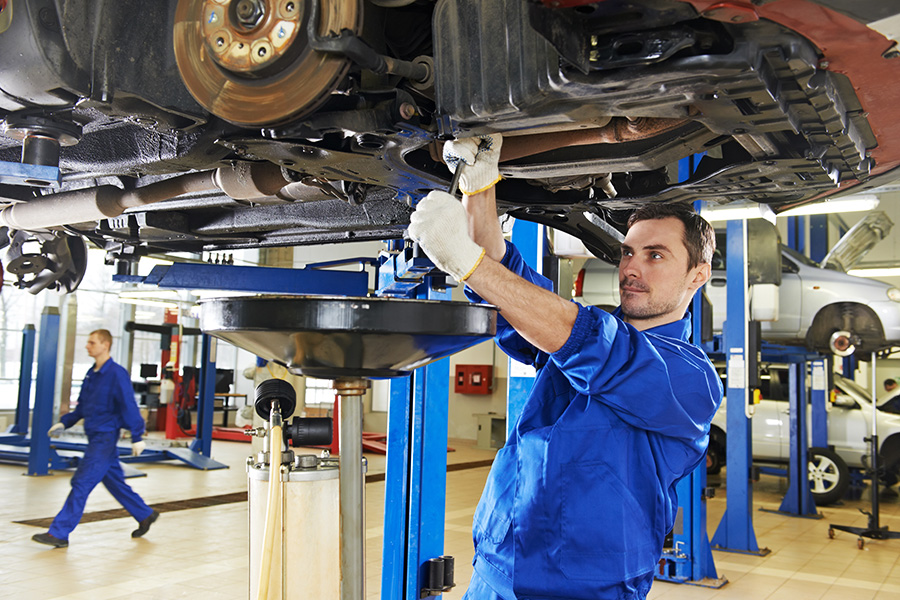 Technician performing routine vehicle maintenance at Boyd GMC of Emporia's GMC Service Center