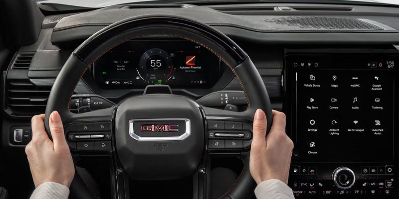 2026 GMC Acadia steering wheel and infotainment system.